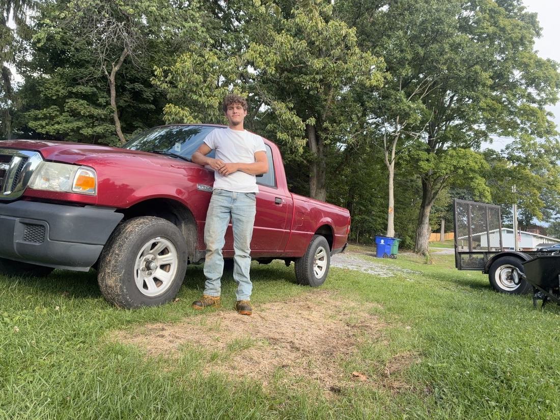 Trevor Thomas with his truck and trailer, ready for a job anywhere in the New River Valley, VA